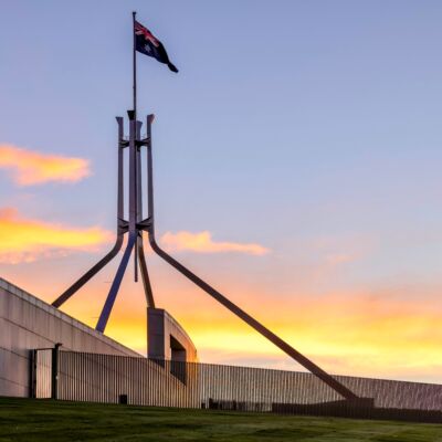 Australian Parliament House Canberra Australian Capital Territory. Showing the roof at sunset and the Australian Flag