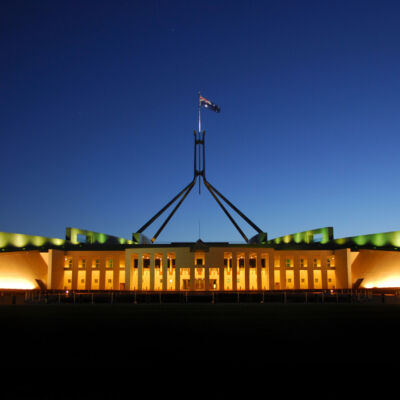 The Parliament House illuminated at dusk in the Australian Capital Territory, Canberra, Australia