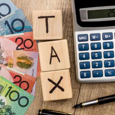 wooden cubes with text tax australian dollar pen and calculator