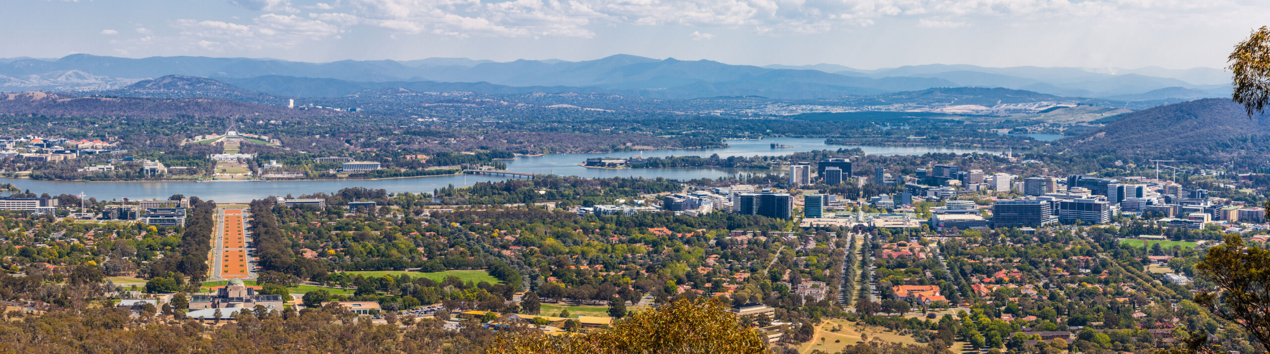 View of Canberra from Mount Ainslie lookout - ANZAC Parade leading up to the Parliament and modern architecture. ACT, Australia